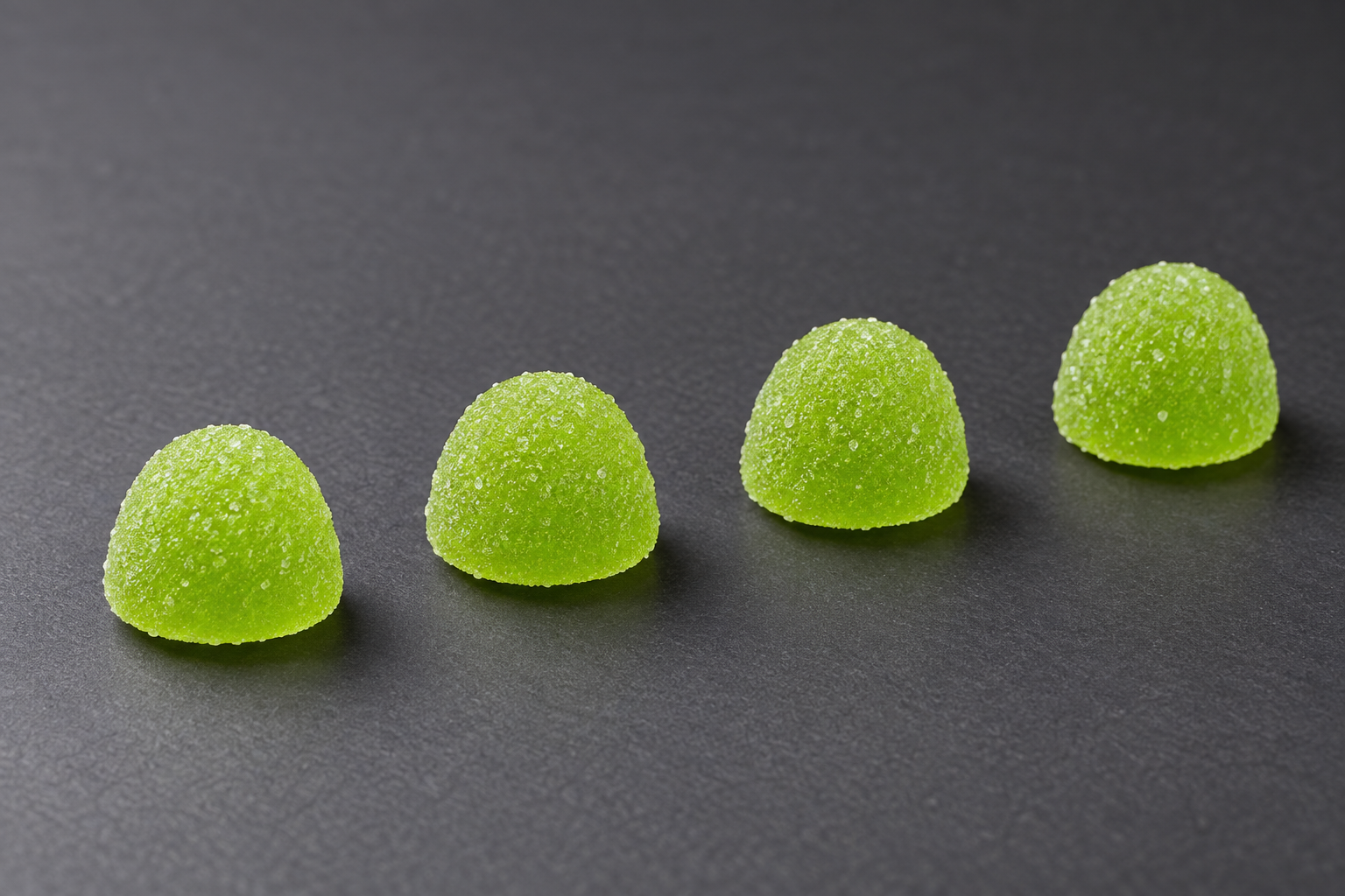 Four Green Apple gummies, illustrating the labeled serving.